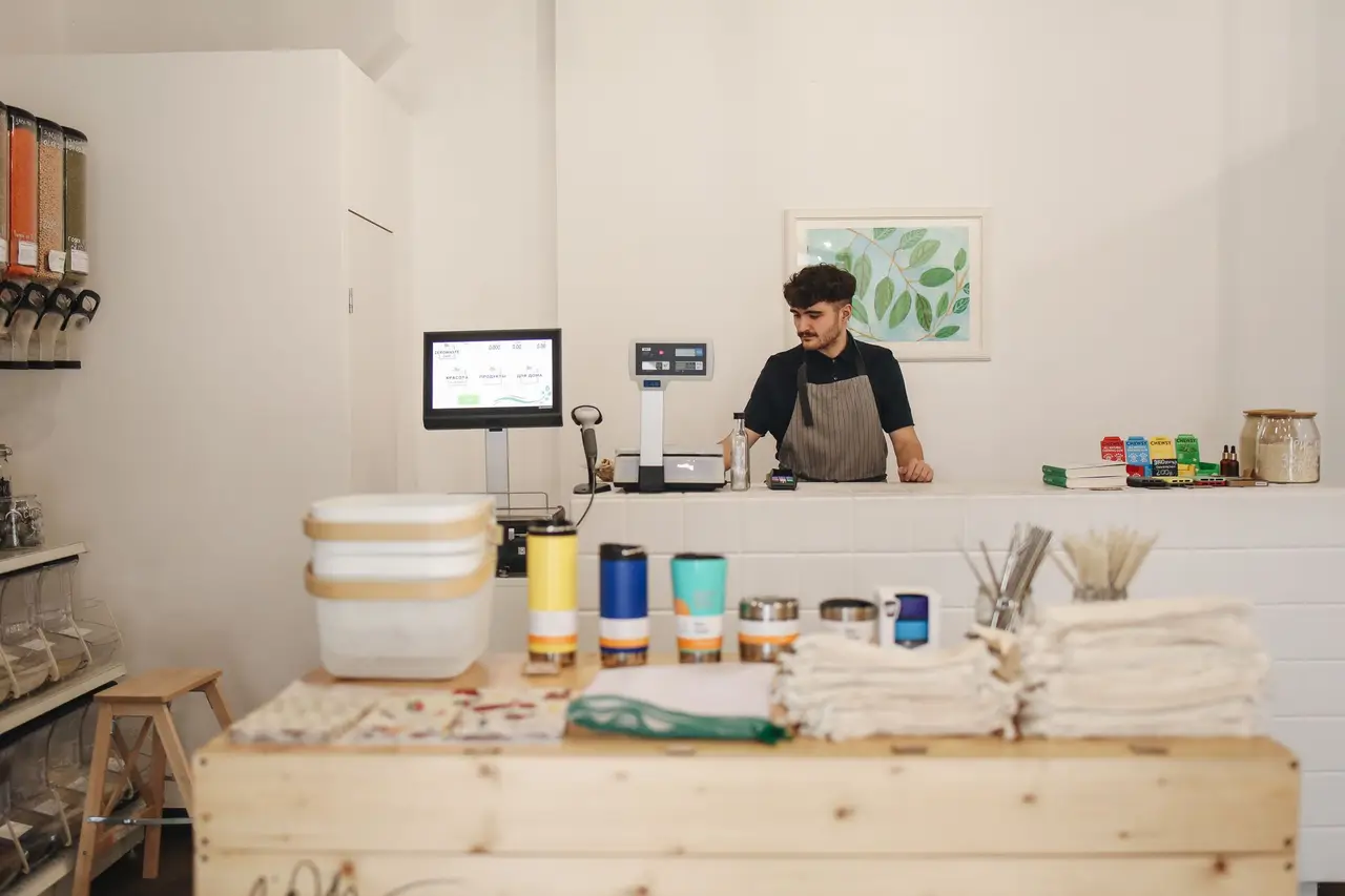 A small business owner at their shop counter