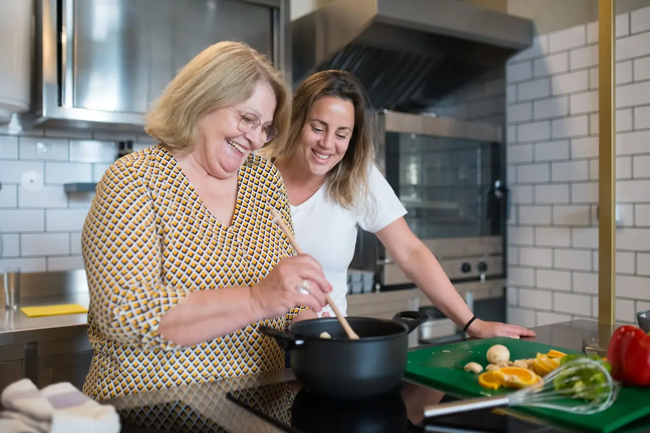 A person cooking in their home kitchen with support